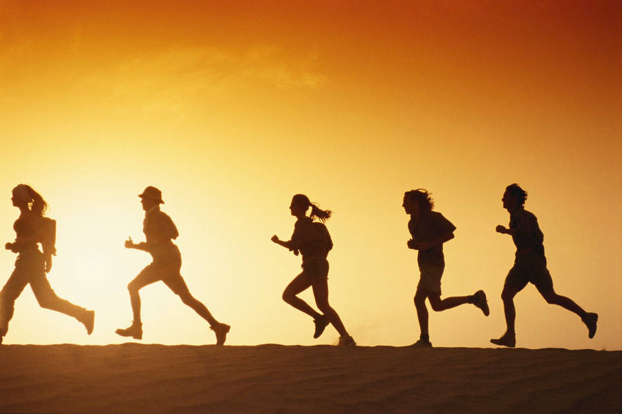 Download Running People Against Sunset Wallpaper | Wallpapers.com