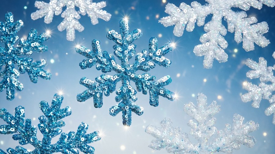 Fiocchi di neve con paillettes che brillano in un cielo blu sfumato con scintille simili a stelle.