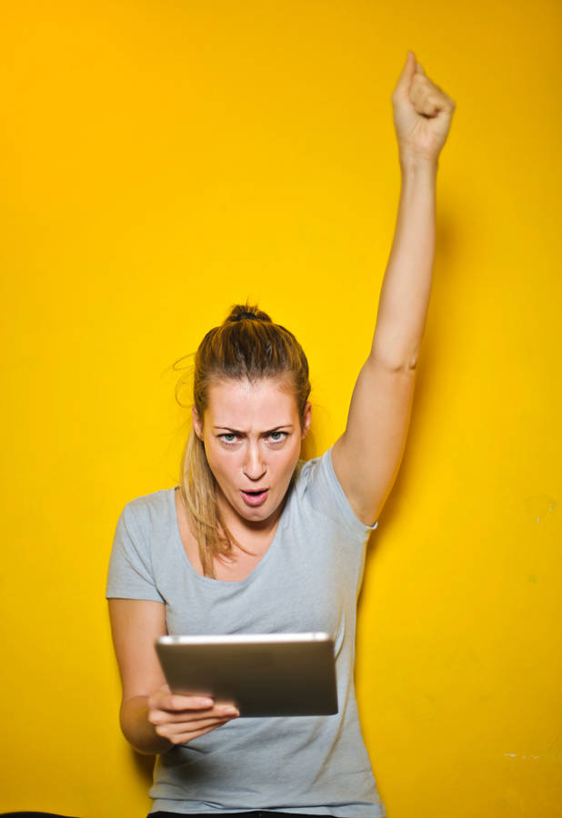 Excited Woman Holding An iPad