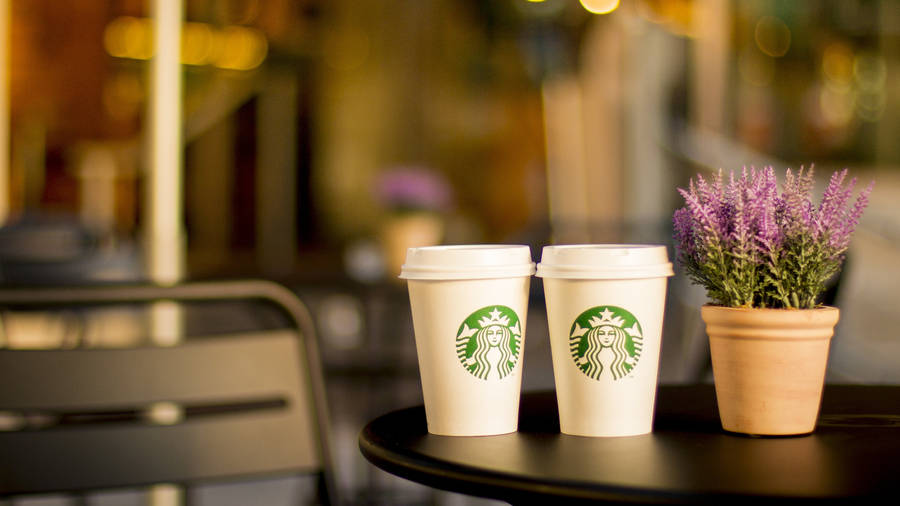 Two Starbucks Styro Cups On Table wallpaper