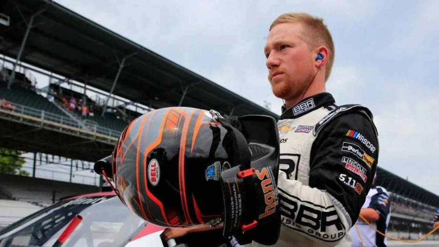 Download Tyler Reddick Fixing His Helmet Wallpaper | Wallpapers.com