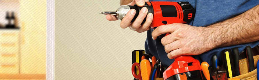 EinMann, der Werkzeuge in seinem Gürtel hält.