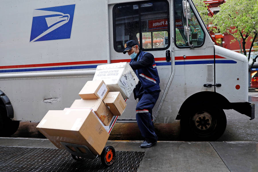 Download Usps Tracking Man Hauling Boxes Wallpaper | Wallpapers.com