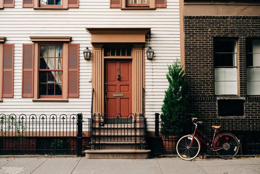 Vintage house and parked bike in a street walk wallpaper