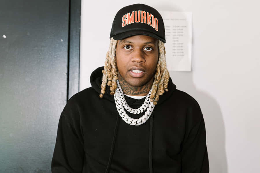 Lil Durk striking a confident pose on stage