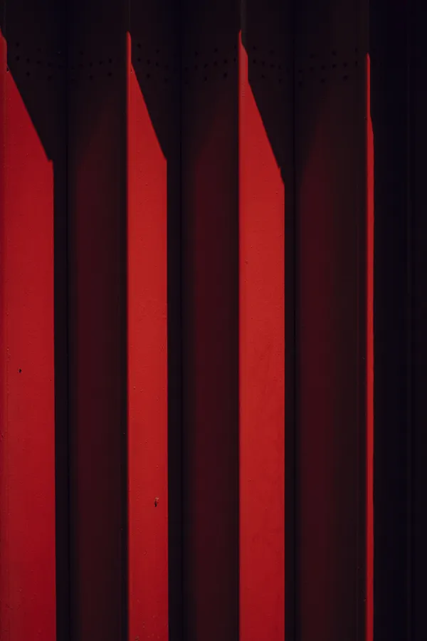 Red wallpaper of red surface with shadow with triangle edges.