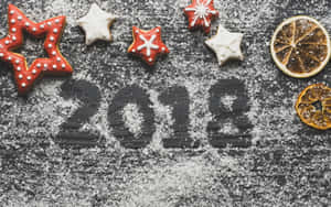 Star cookies and dried oranges around the year 2018 in powdered sugar. — 2018 Picture