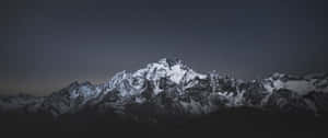 Snowy mountain range under a starry night sky with faint aurora glow. — 4K 16 9 Winter Picture