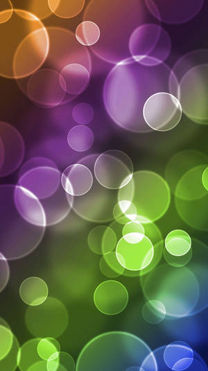 Soft glowing circles in purple green and orange create a vibrant abstract background. — Aesthetic Bubbles Picture