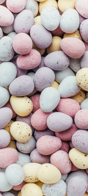 A pile of pastel speckled chocolate eggs in soft muted tones. — Aesthetic Easter Picture