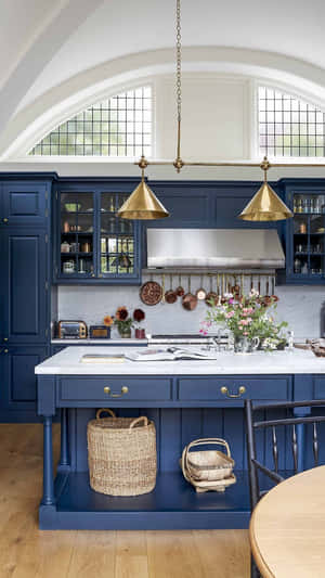 Blue kitchen with marble countertops brass lights and wooden floors. — Kitchen Wallpaper
