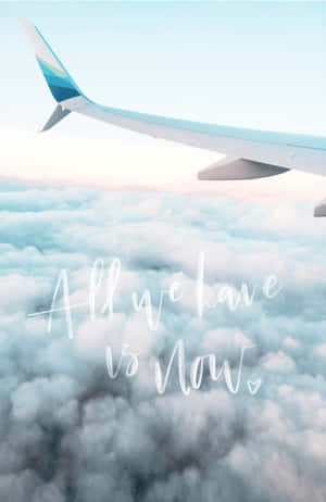 Airplane wing soaring above clouds with text 'All we have is now' — Airplane Background