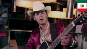 Young musician in cowboy hat playing electric guitar on stage.
