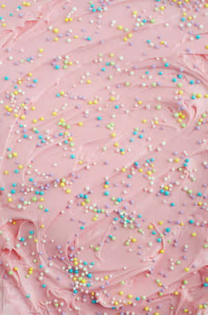 Pink frosting topped with colorful sprinkles for a sweet dessert treat. — Baking iPhone Picture