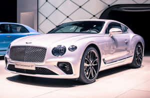 Silver Bentley Continental GT luxury sports car on display at auto show. — Aesthetic Car Picture