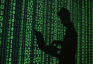 Silhouette of a person in front of falling green binary code. — Non Binary Wallpaper