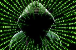 Silhouette of a hooded person surrounded by green digital code. — Non Binary Wallpaper