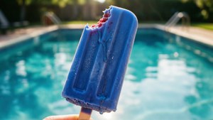 A bitten popsicle by a pool in summer.