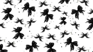 Black ink bows and splatters on white background