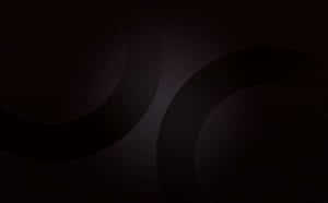 Fondo oscuro abstracto con formas circulares brillantes.