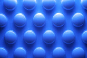 Blaue strukturierte Oberfläche mit erhabenen kreisförmigen Noppen in einem Gittermuster. — Blue Pattern Wallpaper
