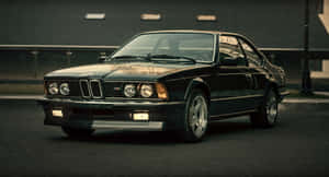Classic black BMW M6 sports car parked on city street at dusk. — Bmw Android Picture