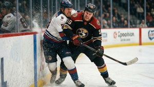 McAvoy battling along the boards for puck — Charles Mcavoy Picture