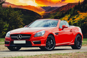 Red Mercedes-Benz SLK convertible parked in mountainous landscape at sunset. — This Is The Way Picture