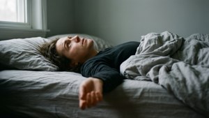 Seseorang berbaring di tempat tidur menatap langit-langit dengan apatis