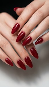 A stunning close-up of glossy cherry red nails on elegant hands, perfect for a chic wallpaper.