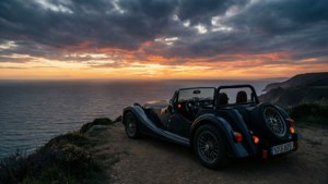 Silhouette de la Morgan Roadster sur une falaise au coucher du soleil