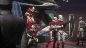 Stormtroopers in red and white armor stand guard near a spaceship in a futuristic hangar.