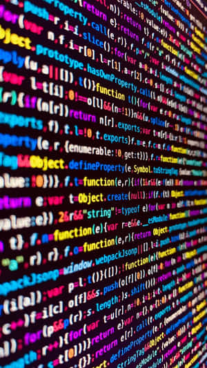 Uma parede de linhas de código coloridas e brilhantes em uma tela digital escura. — Codificação Papéis de Parede