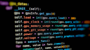 Close-up of colorful programming code on a dark screen. — Code Wallpaper