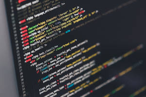 Close-up of colorful programming code on a computer screen. — Code Wallpaper