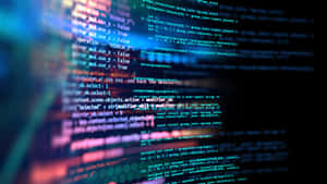Close-up of glowing code lines on a dark screen with blurred background. — Coding Picture