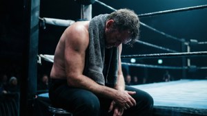 Emotional shot of Pete Latzo resting in the ring corner, exhaustion captured in cool tones. — Pete Latzo Picture