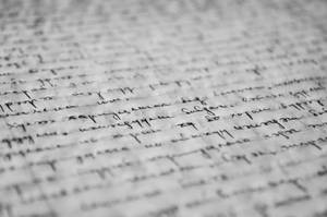Close-up of handwritten cursive text on textured paper with shallow focus. — Composition Notebook Background