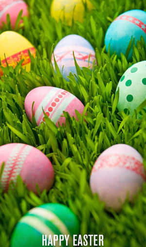 Colorful decorated Easter eggs in green grass with 'Happy Easter' text.