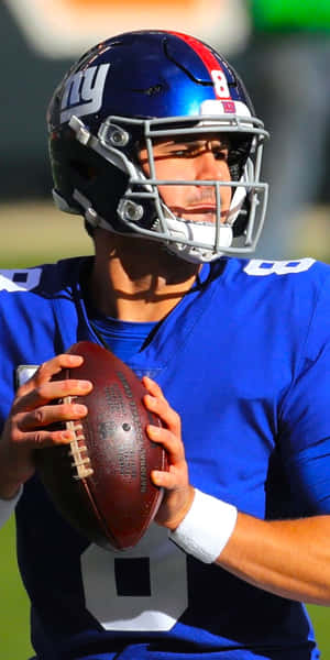 Football quarterback in blue uniform holding a football on field. — Wendy williams Wallpaper