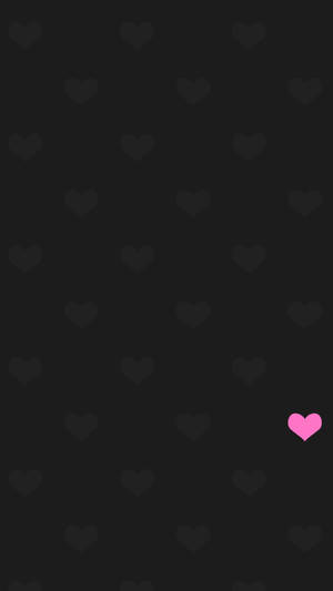 Dark background with gray hearts and one pink heart in bottom right. — Pink Heart Picture