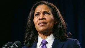 A woman in a suit and purple tie looks upward with a concerned expression. — Kamala Harris Picture
