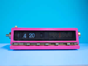 Pink vintage radio clock showing 4 20 on blue background — 4K Phone Background