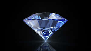 A blue diamond with sparkling facets on a black reflective surface. — Diamond Aesthetic Picture