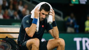 Tennis player wiping sweat with towel during match — Novak Djokovic Background