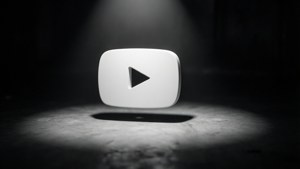 Faretto drammatico su un'icona 3D bianca di YouTube in una stanza buia.
