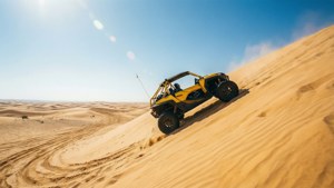 Buggy amarelo sobe uma duna de areia no deserto.
