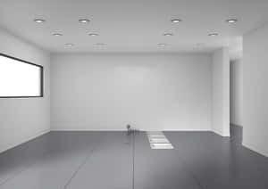 Stanza vuota minimalista con pareti bianche, pavimento grigio e luci da soffitto incassate. — Immagini di stanze vuote Sfondi