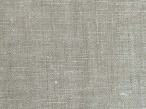 Close-up of beige linen fabric showing woven texture and natural fibers.