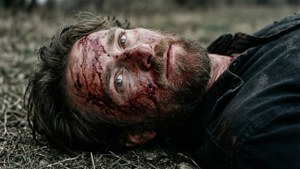 An injured Erwin lying on the battlefield, a poignant and emotional moment.
